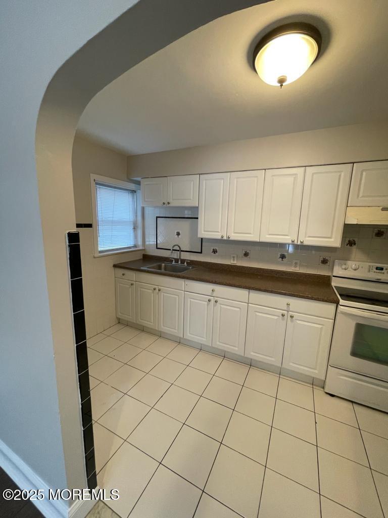 286 Cleveland Avenue, Unit 1 Long Branch, NJ 07740 - Photo 5 of 10 a kitchen with a stove a sink and a refrigerator