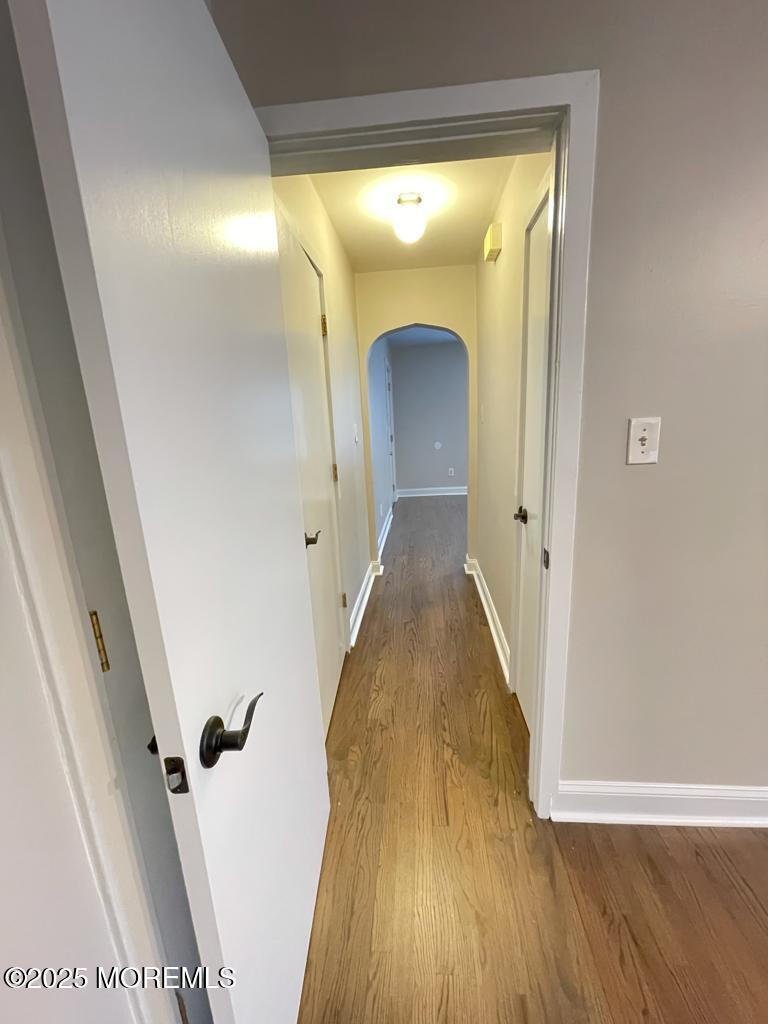 286 Cleveland Avenue, Unit 1 Long Branch, NJ 07740 - Photo 6 of 10 a view of a hallway with wooden floor and staircase