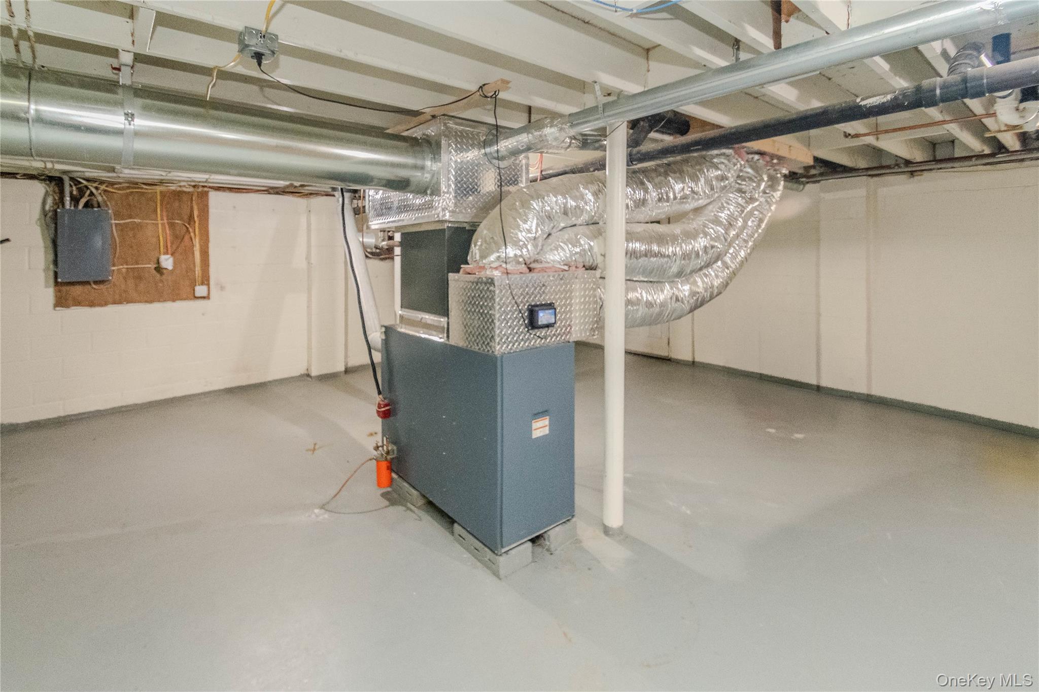 15 Van Dewark Road Middletown, NY 10941 - Photo 27 of 41 Utility room featuring a furnace system with exposed ductwork, painted concrete flooring, and exposed ceiling joists