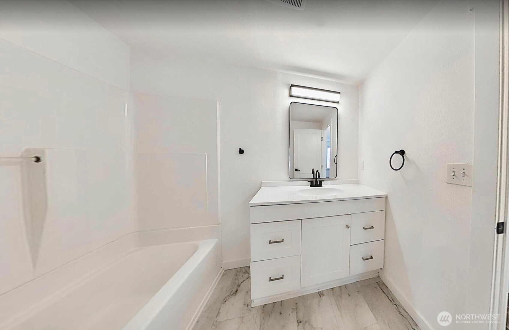 814 5th Street Steilacoom, WA 98388 - Photo 11 of 21 a bathroom with a bathtub sink vanity and mirror