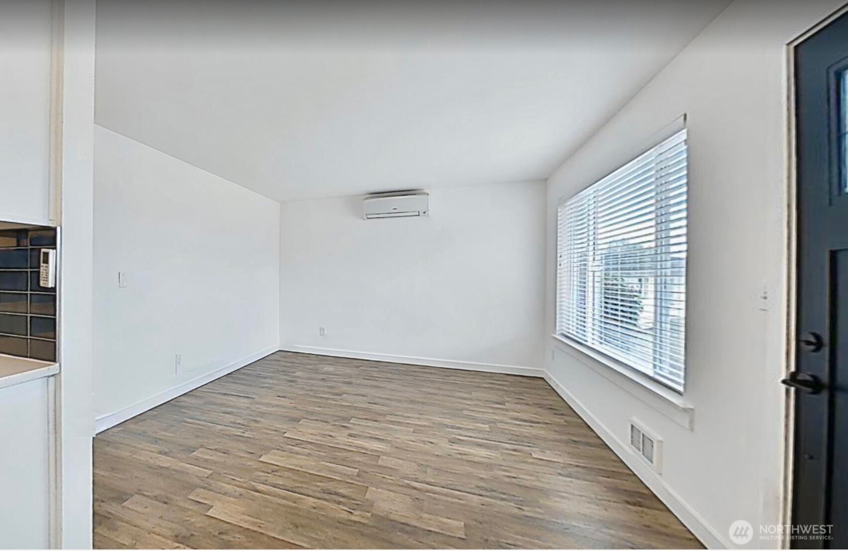 814 5th Street Steilacoom, WA 98388 - Photo 10 of 21 a view of an empty room with wooden floor and a window