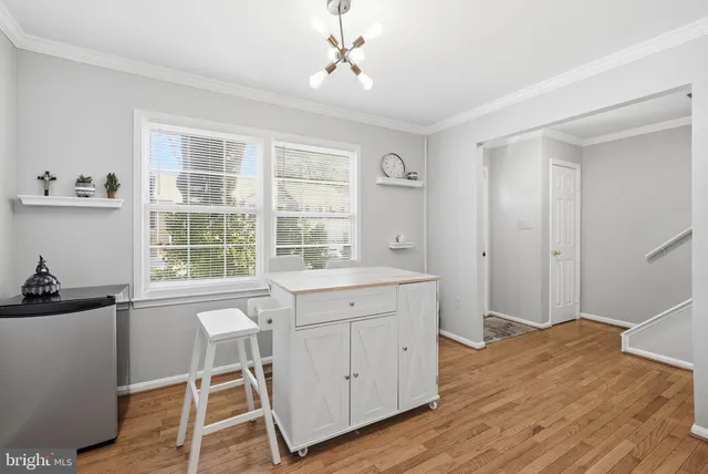 a workspace with a window and wooden floor