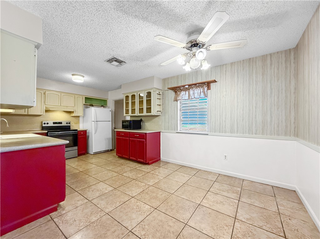 910 Twite Circle Corpus Christi, TX 78418 - Photo 15 of 40 a large kitchen with granite countertop a stove a sink dishwasher and a refrigerator