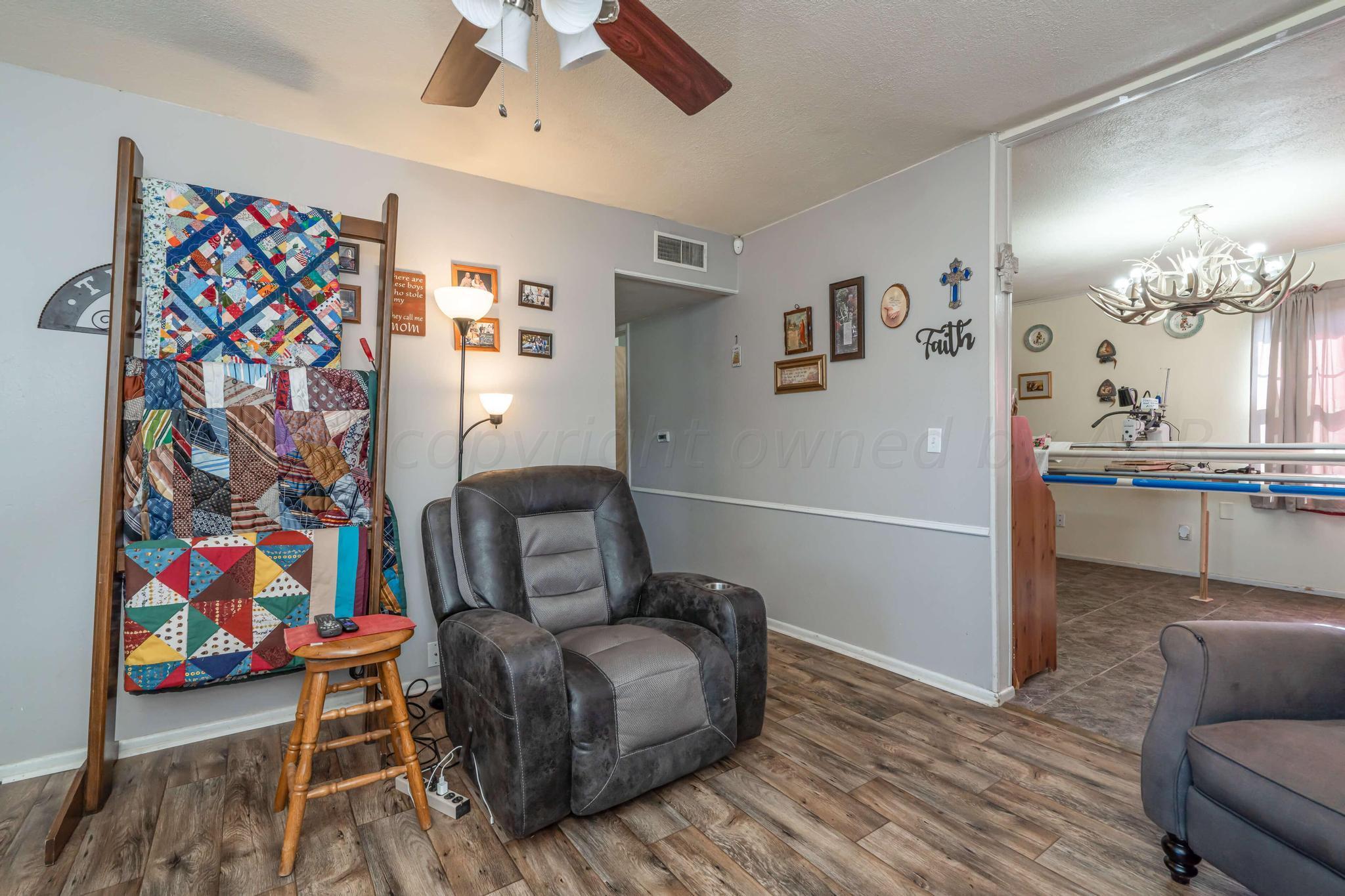 5216 South Travis Street Amarillo, TX 79110 - Photo 5 of 27 a living room with furniture and painting on the wall