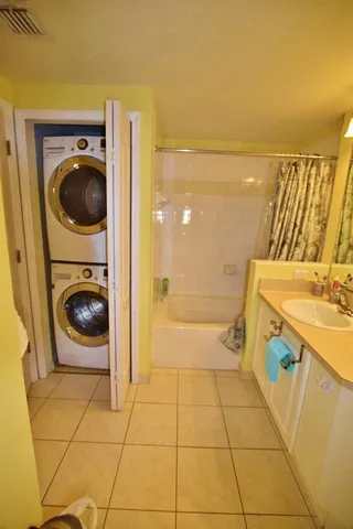 a view of a kitchen with a sink and a washer dryer