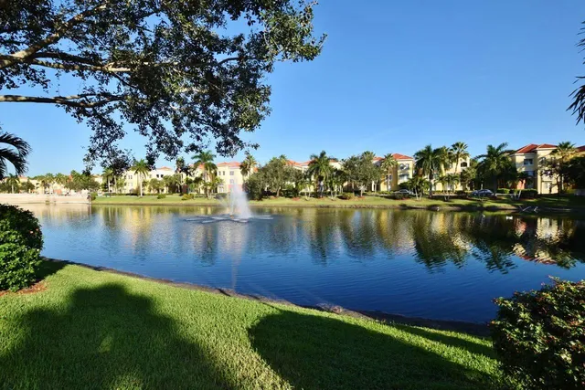 a view of a lake with houses in the back