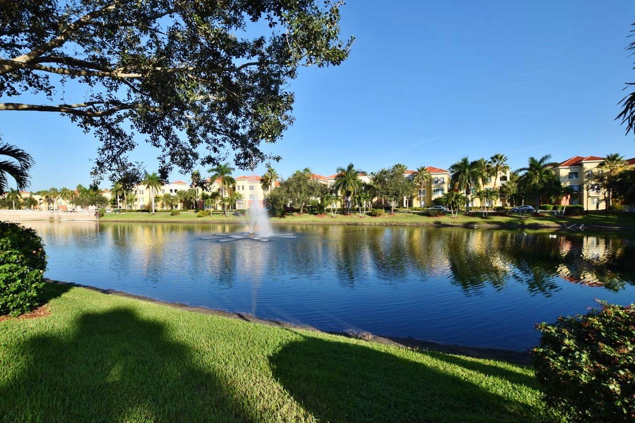 11016 Legacy Drive, Unit 103 Palm Beach Gardens, FL 33410 - Photo 22 of 44 a view of a lake with houses in the back