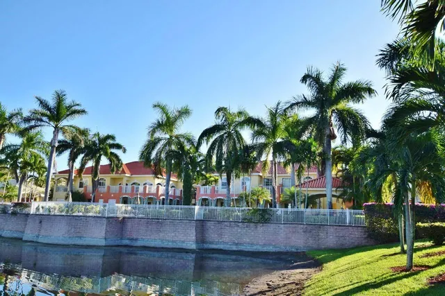 a view of house with palm trees
