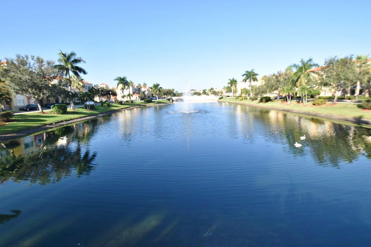 11016 Legacy Drive, Unit 103 Palm Beach Gardens, FL 33410 - Photo 28 of 44 a view of a lake with houses