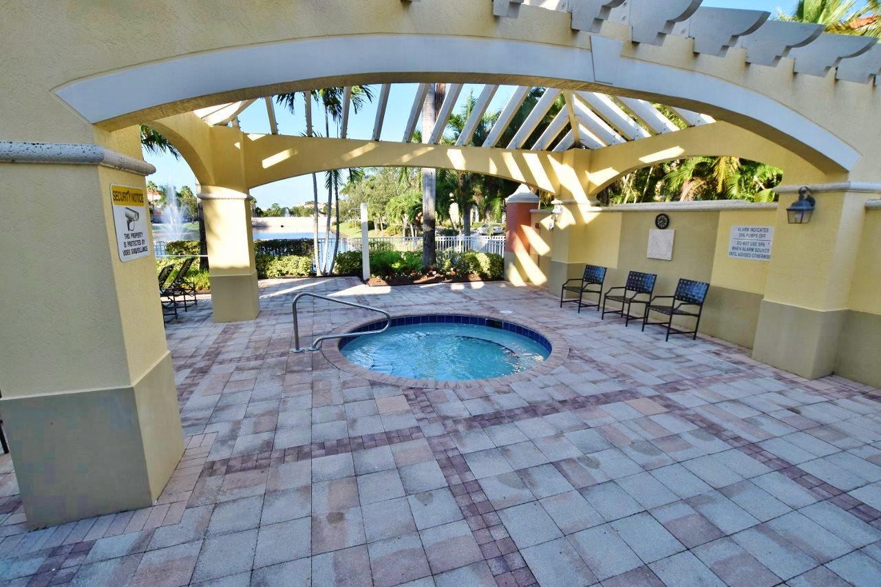11016 Legacy Drive, Unit 103 Palm Beach Gardens, FL 33410 - Photo 30 of 44 a view of a swimming pool with a patio