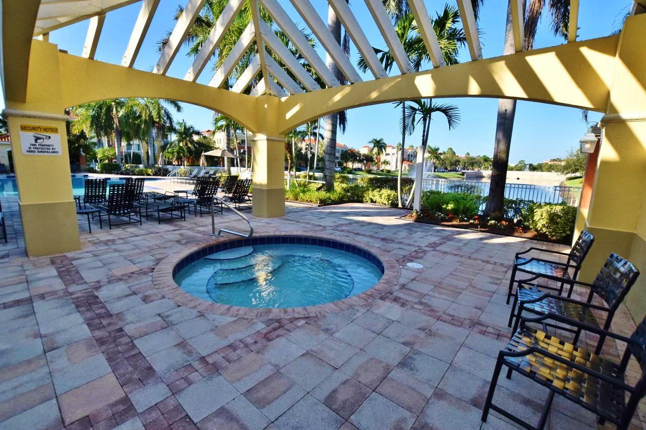 11016 Legacy Drive, Unit 103 Palm Beach Gardens, FL 33410 - Photo 31 of 44 a view of a swimming pool with a patio