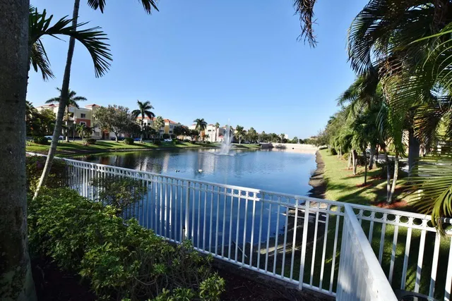 a balcony with wooden floor and lake view