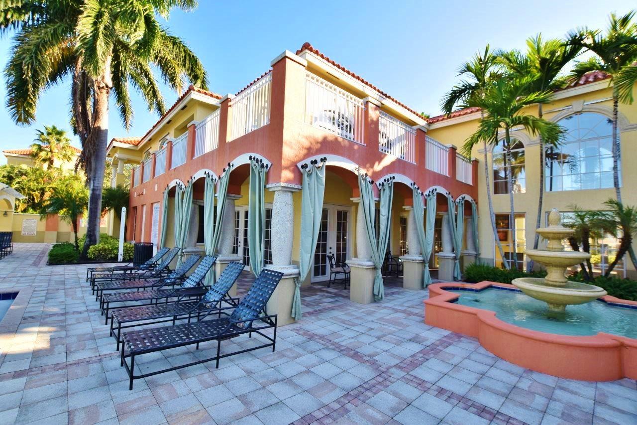11016 Legacy Drive, Unit 103 Palm Beach Gardens, FL 33410 - Photo 36 of 44 a front view of a building with glass windows and door