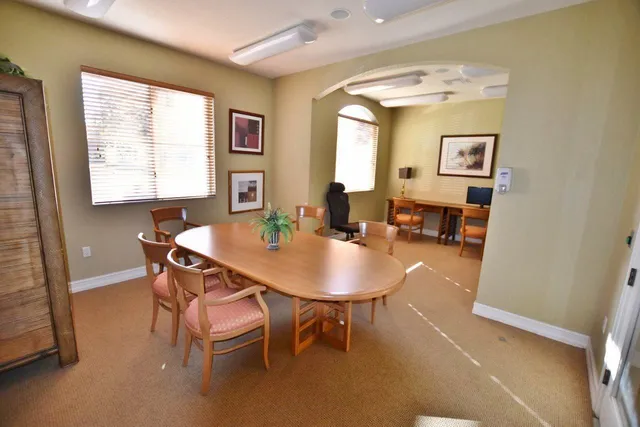a view of a dining room with furniture and a window