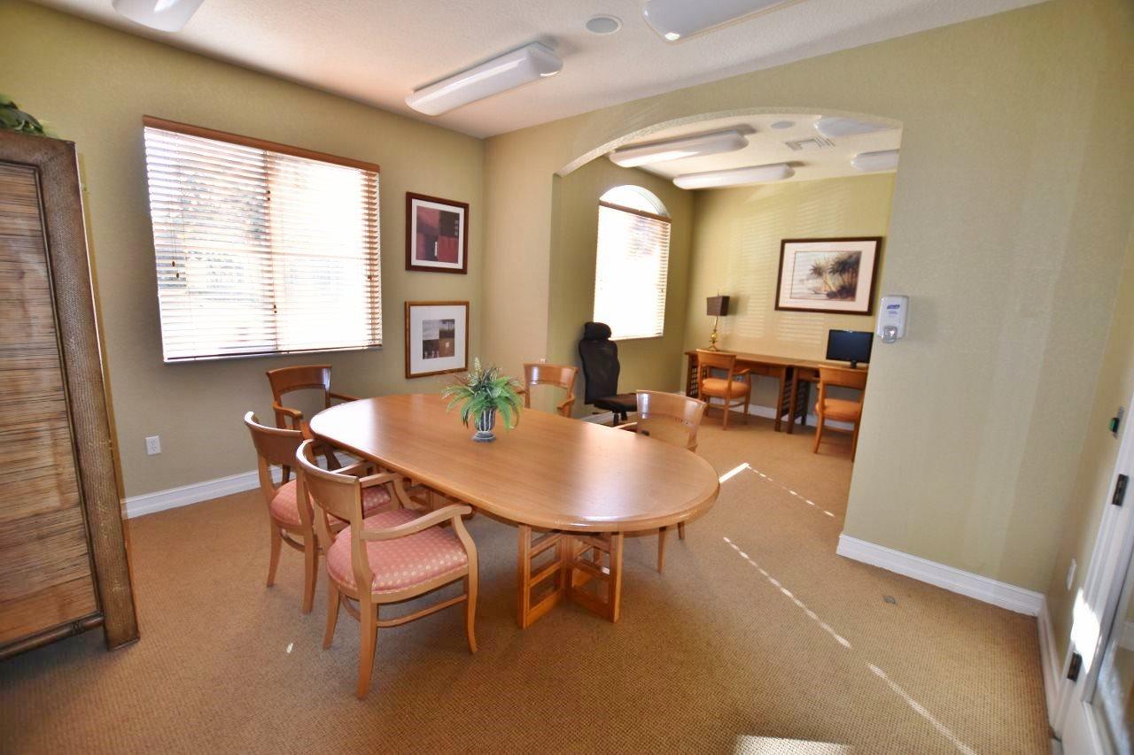 11016 Legacy Drive, Unit 103 Palm Beach Gardens, FL 33410 - Photo 39 of 44 a view of a dining room with furniture and a window