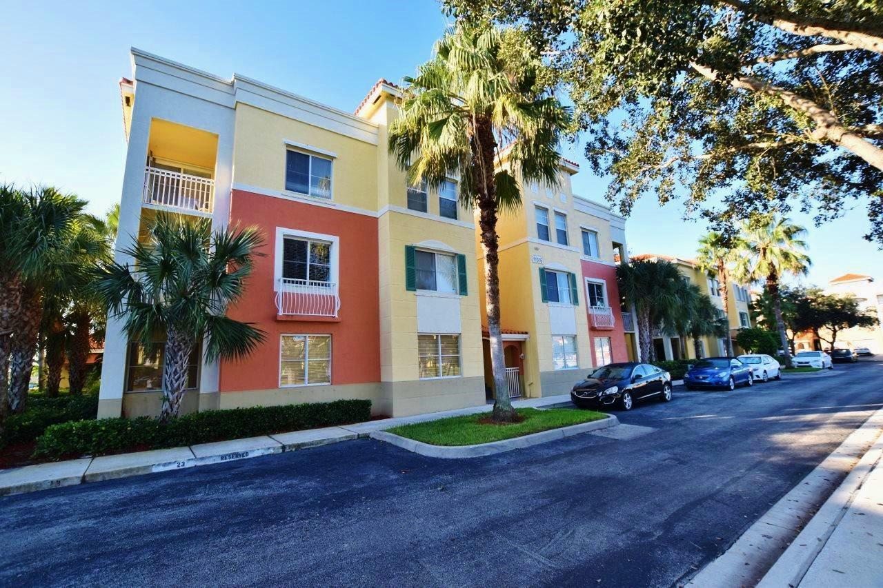 11016 Legacy Drive, Unit 103 Palm Beach Gardens, FL 33410 - Photo 4 of 44 a front view of a house with a garden