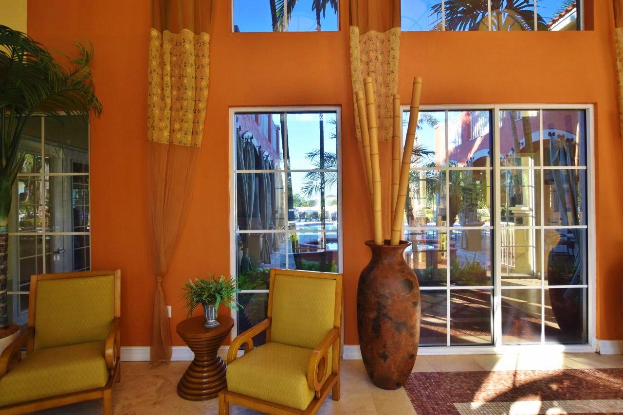 11016 Legacy Drive, Unit 103 Palm Beach Gardens, FL 33410 - Photo 42 of 44 a view of a patio with couches chairs and wooden floor