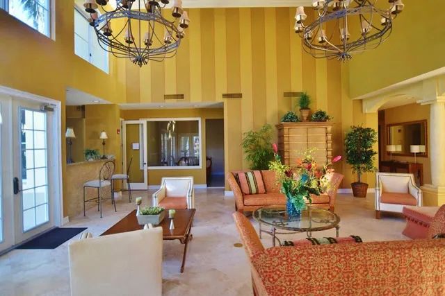 a living room with fireplace furniture and a chandelier