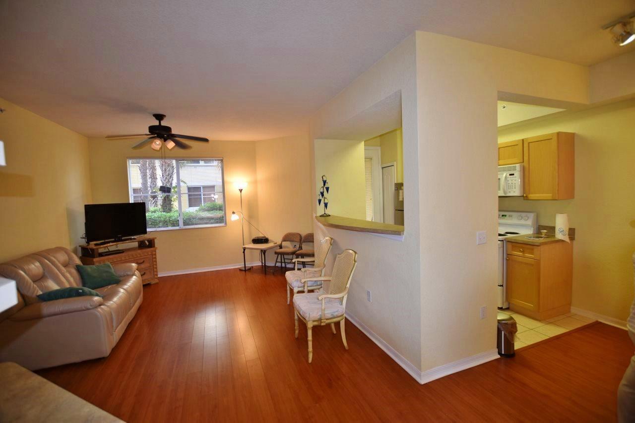 11016 Legacy Drive, Unit 103 Palm Beach Gardens, FL 33410 - Photo 6 of 44 a living room with furniture and a flat screen tv