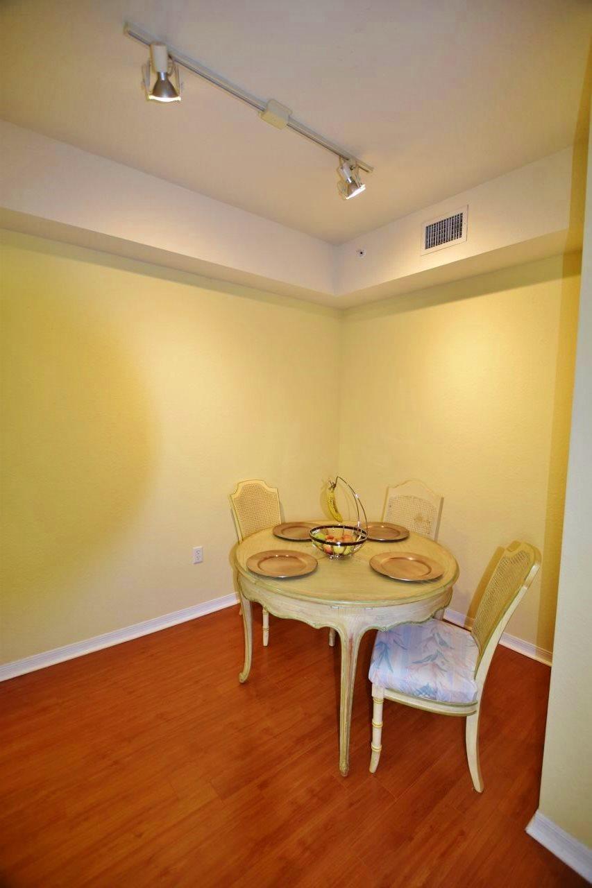 11016 Legacy Drive, Unit 103 Palm Beach Gardens, FL 33410 - Photo 7 of 44 a view of a dining room with furniture and wooden floor