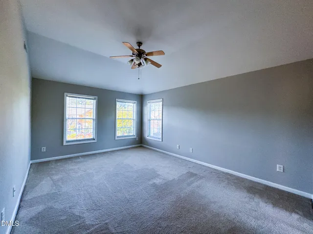 a view of room with a ceiling fan and window
