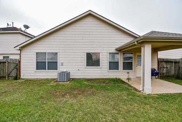 a view of a house with a backyard and a small yard