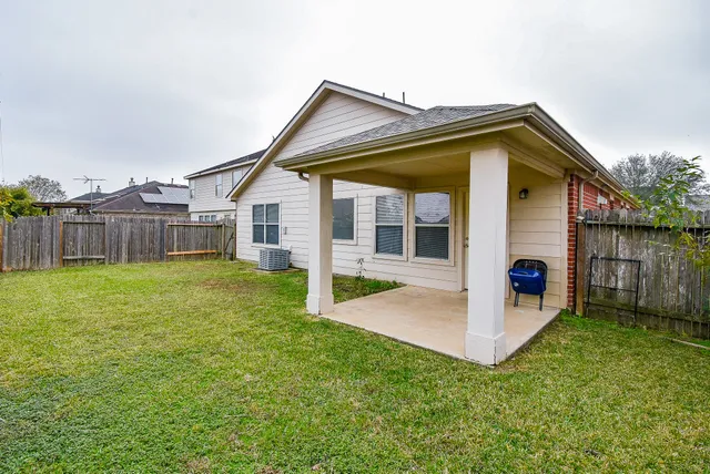a backyard of a house with table and chairs
