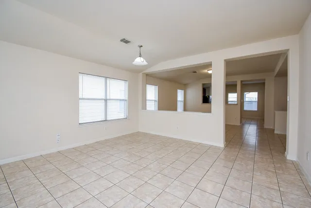an empty room with windows and closet