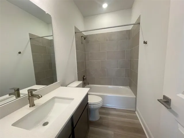 an empty room with a chandelier fan and windows