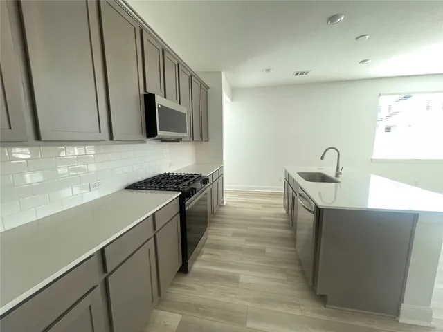 a view of a room with wooden floor