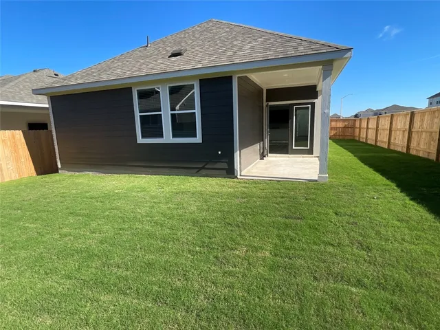 a view of a house with a backyard