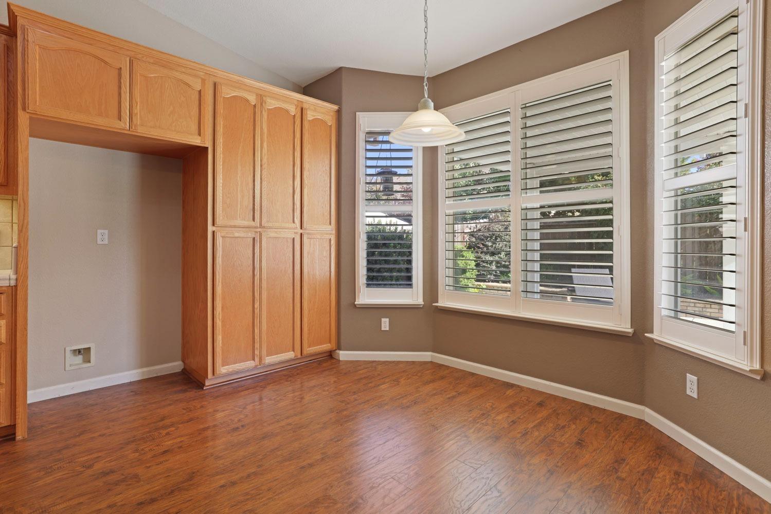 4316 Versailles Drive Modesto, CA 95356 - Photo 12 of 45 a view of an empty room with a window and wooden floor
