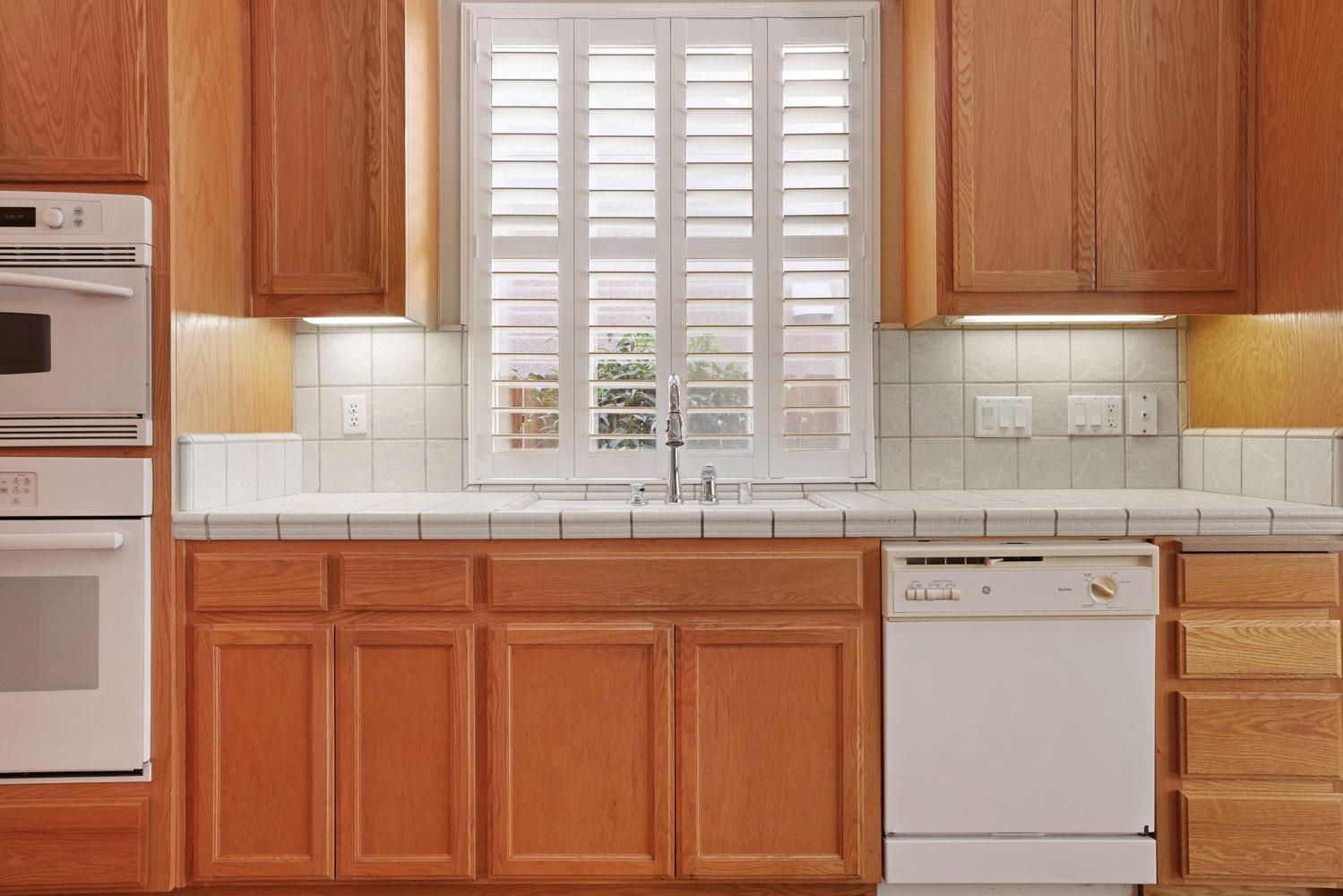 4316 Versailles Drive Modesto, CA 95356 - Photo 13 of 45 a kitchen with granite countertop white cabinets and sink
