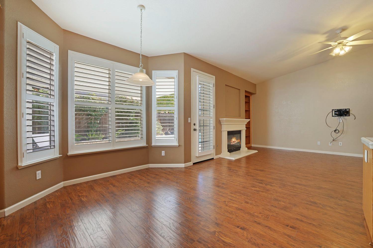 4316 Versailles Drive Modesto, CA 95356 - Photo 14 of 45 a view of an empty room with a window and wooden floor