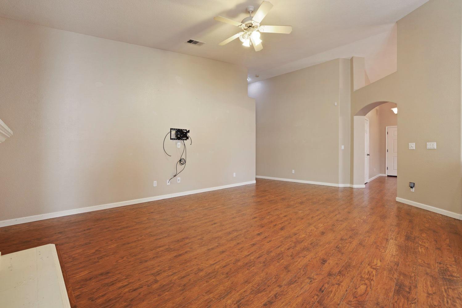 4316 Versailles Drive Modesto, CA 95356 - Photo 16 of 45 a view of a room with wooden floor and ceiling fan