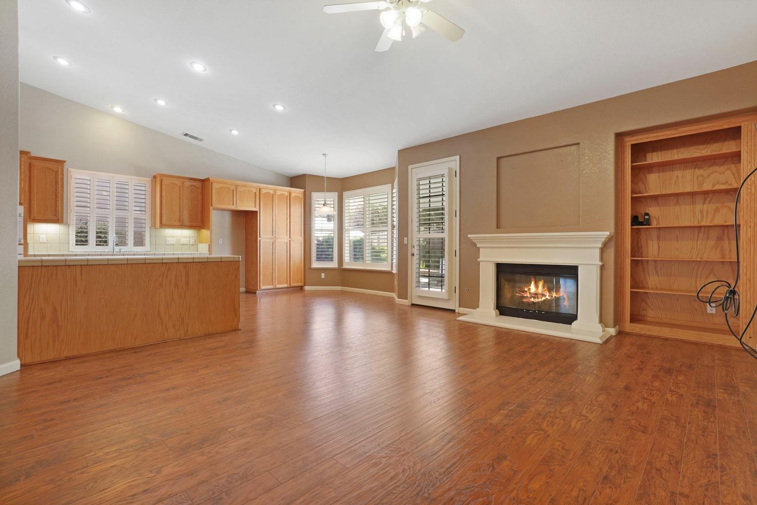 4316 Versailles Drive Modesto, CA 95356 - Photo 17 of 45 a view of a livingroom with wooden floor and a fireplace