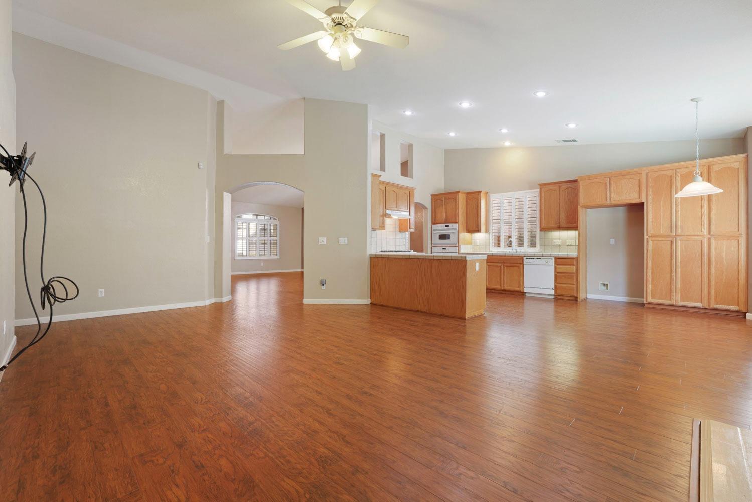 4316 Versailles Drive Modesto, CA 95356 - Photo 18 of 45 a view of a kitchen with kitchen island wooden floors wooden floor and stainless steel appliances