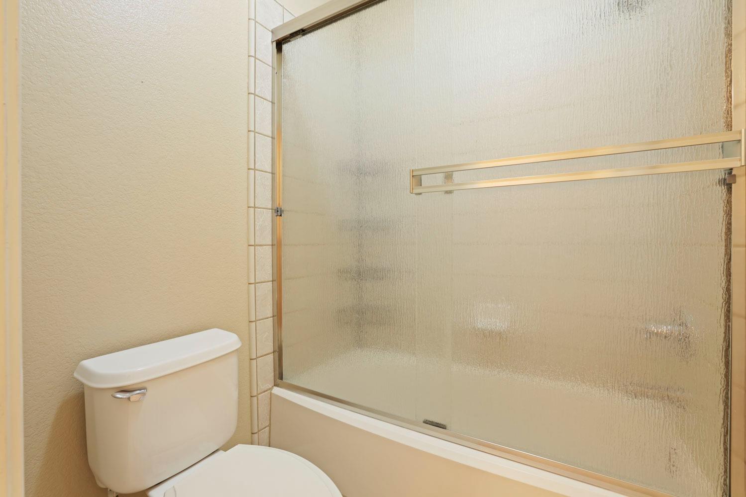 4316 Versailles Drive Modesto, CA 95356 - Photo 21 of 45 a bathroom with a shower and a toilet