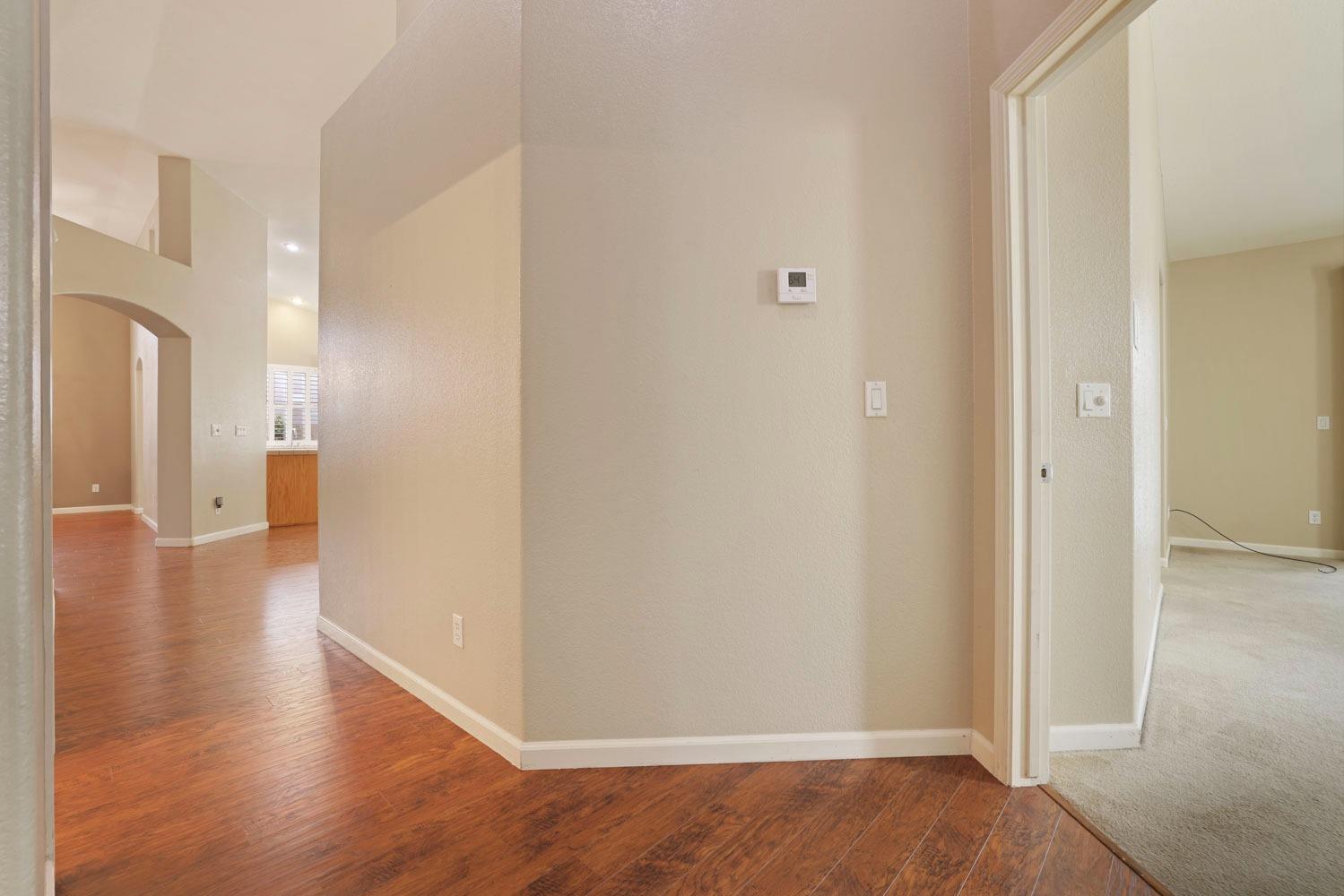 4316 Versailles Drive Modesto, CA 95356 - Photo 23 of 45 a view of a hallway with wooden floor