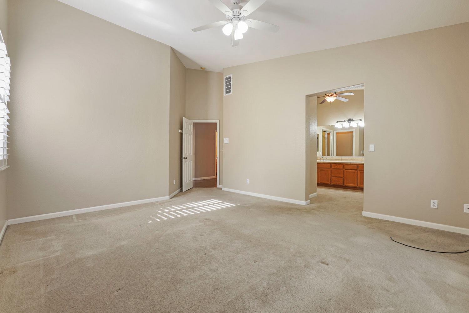 4316 Versailles Drive Modesto, CA 95356 - Photo 25 of 45 a view of an empty room with a chandelier fan