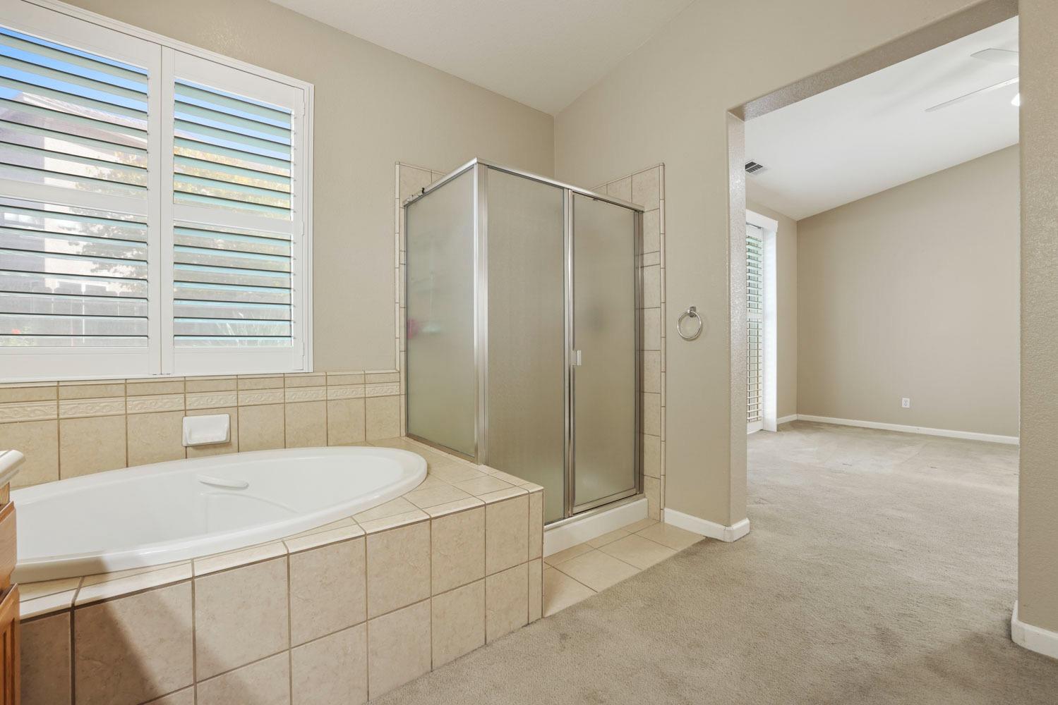 4316 Versailles Drive Modesto, CA 95356 - Photo 28 of 45 a bathroom with a bathtub and a shower