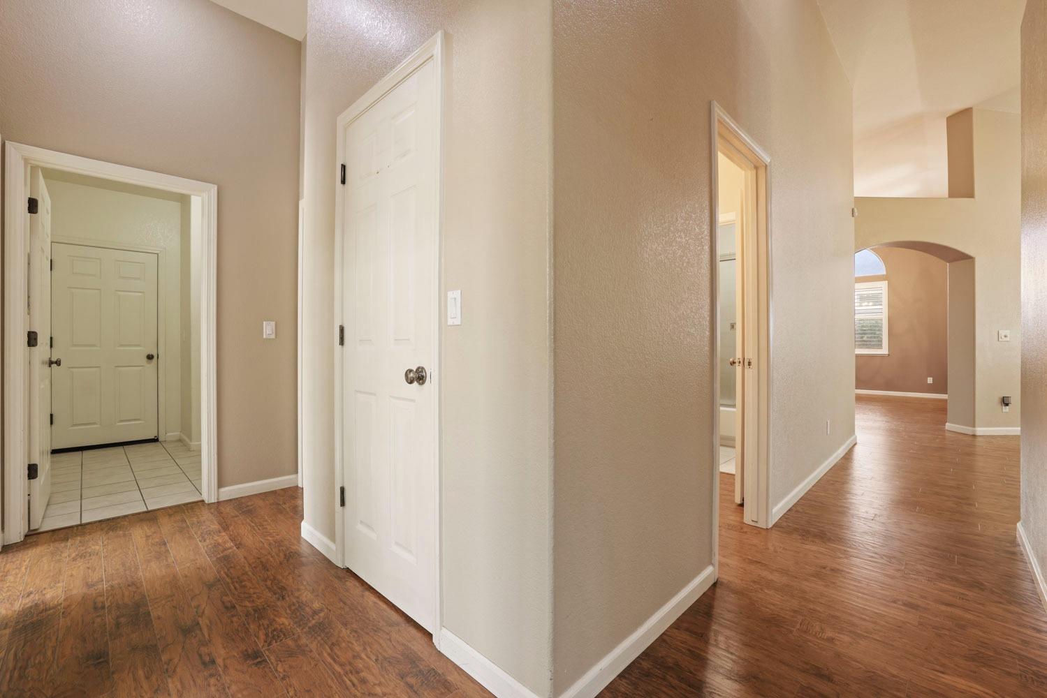 4316 Versailles Drive Modesto, CA 95356 - Photo 30 of 45 a view of a hallway with wooden floor