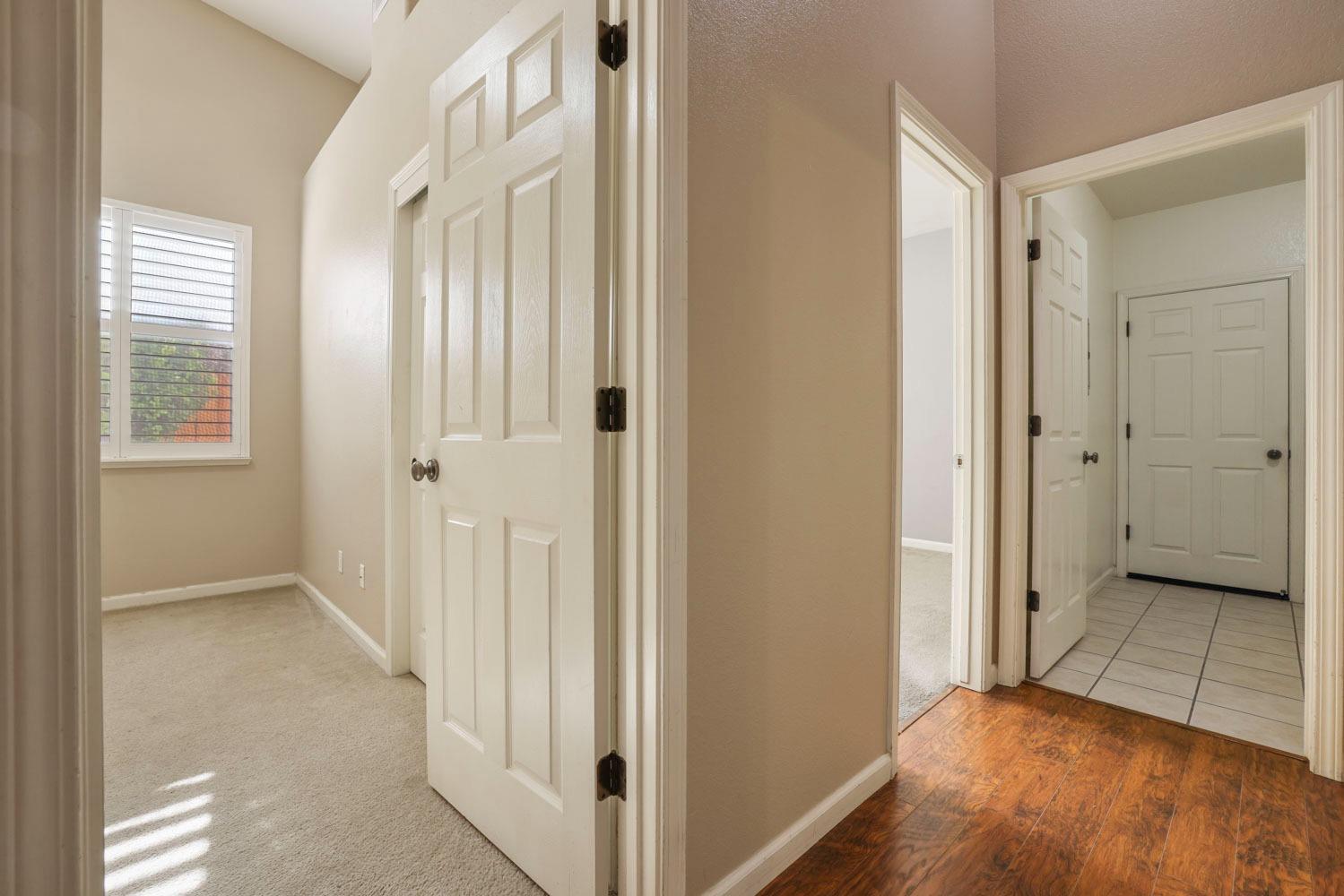 4316 Versailles Drive Modesto, CA 95356 - Photo 31 of 45 a view of a hallway with wooden floor and a room
