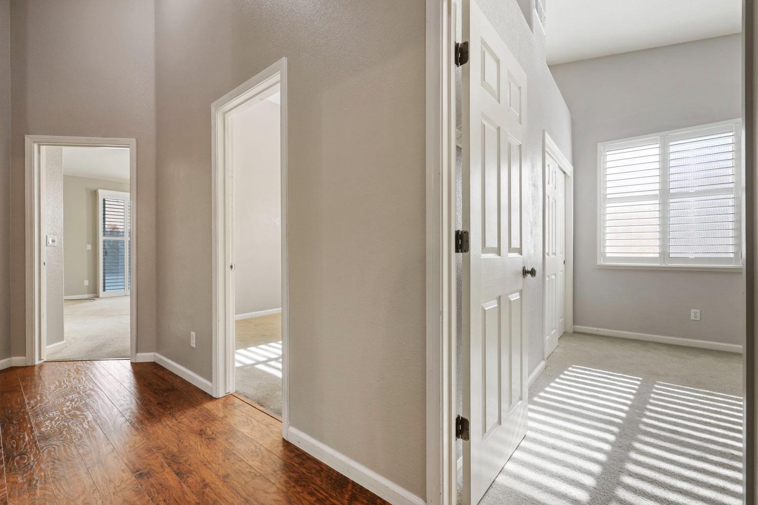 4316 Versailles Drive Modesto, CA 95356 - Photo 33 of 45 a view of a hallway with wooden floor and a window