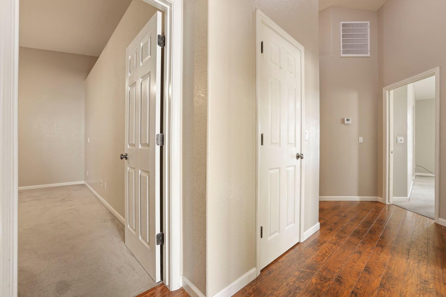 4316 Versailles Drive Modesto, CA 95356 - Photo 38 of 45 a view of a hallway with wooden floor