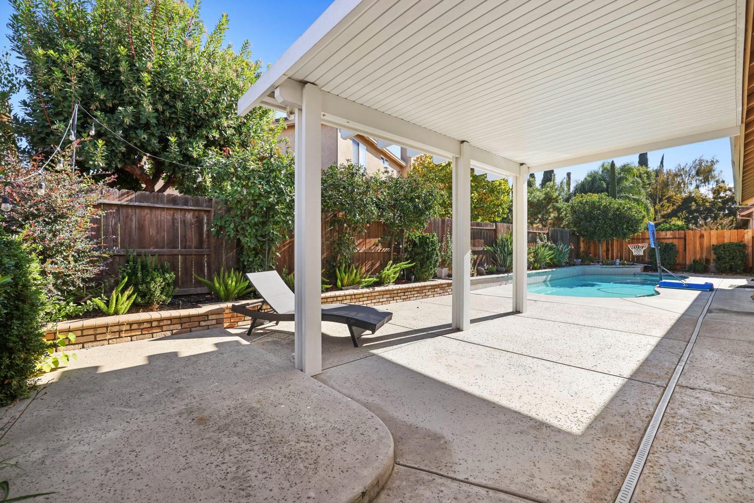 4316 Versailles Drive Modesto, CA 95356 - Photo 40 of 45 a view of a patio with a table chairs and a floor to ceiling window