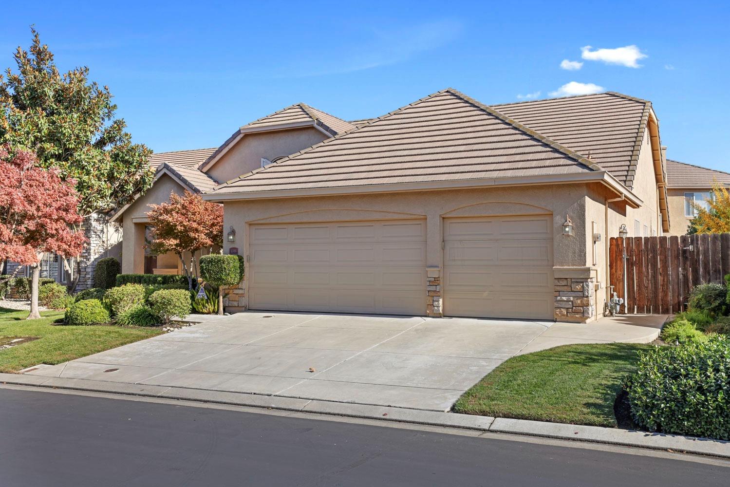 4316 Versailles Drive Modesto, CA 95356 - Photo 4 of 45 a front view of a house with a yard and garage