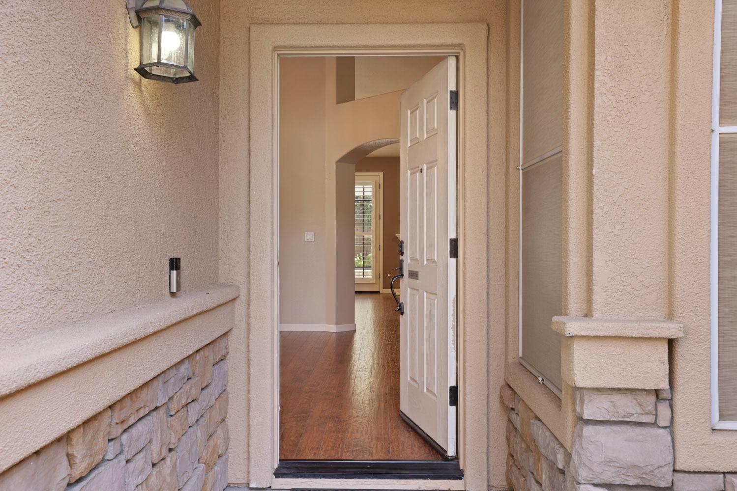 4316 Versailles Drive Modesto, CA 95356 - Photo 5 of 45 a view of a hallway with wooden floor and staircase