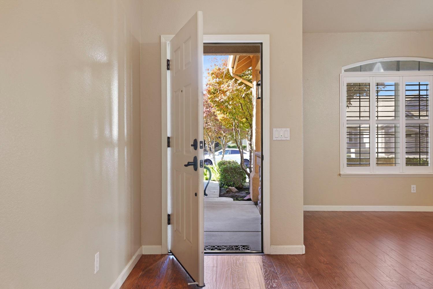 4316 Versailles Drive Modesto, CA 95356 - Photo 6 of 45 a view of an entryway with wooden floor and a livingroom