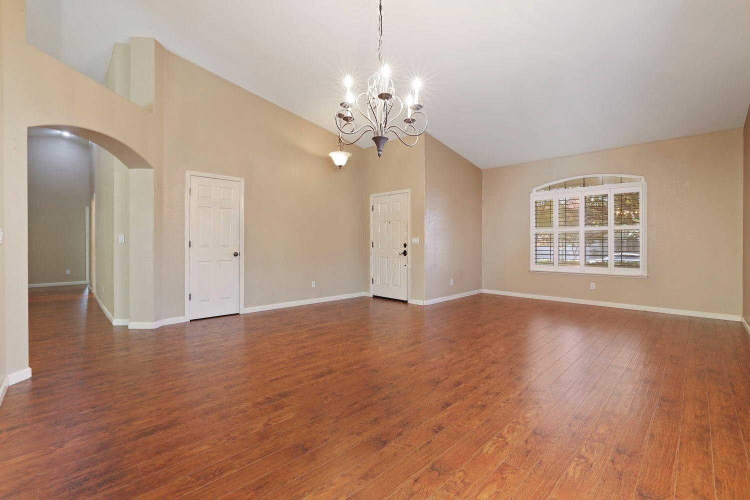 4316 Versailles Drive Modesto, CA 95356 - Photo 9 of 45 a view of livingroom with window wooden floor and chandelier
